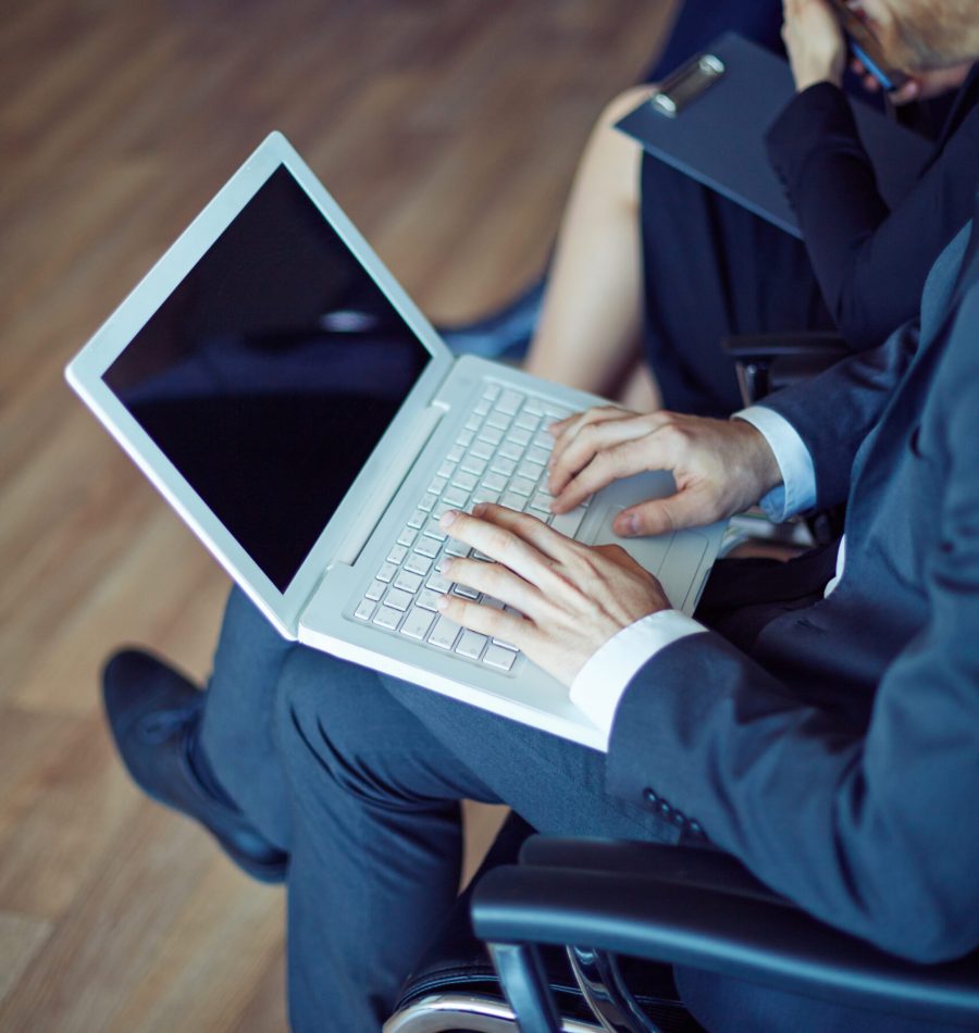 Male employee typing at working seminar or conference